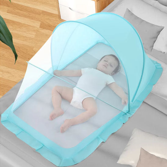 Bébé endormi protégé par moustiquaire lit bébé