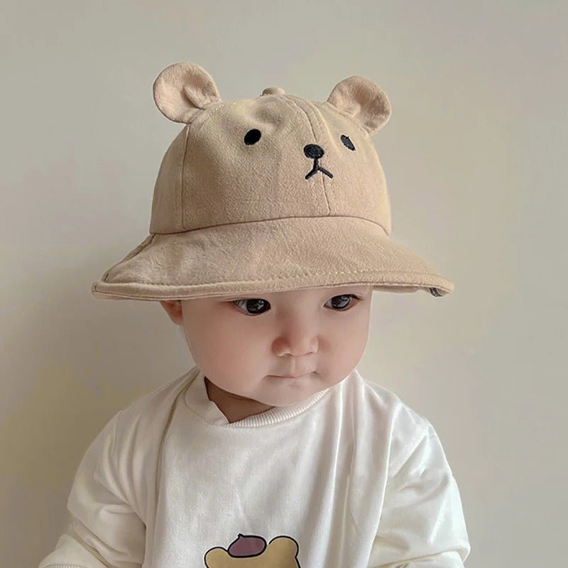 Bébé mignon avec chapeau bébé bob ourson café.