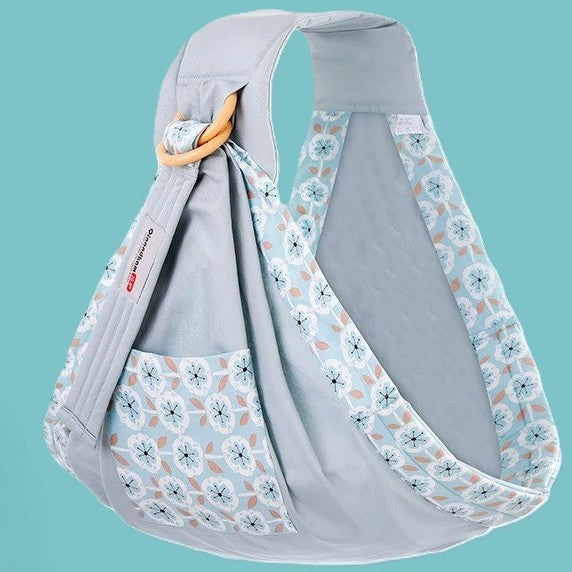 Porte bébé gris au motif fleuri.
