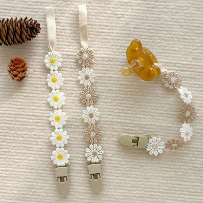 Attache tétine marguerites avec clip sécuritaire.