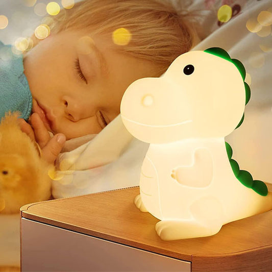 Enfant endormi avec veilleuse bebe T-Rex