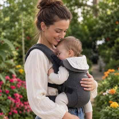 Maman dans le jardin avec son porte bébé évolutif dark gray.