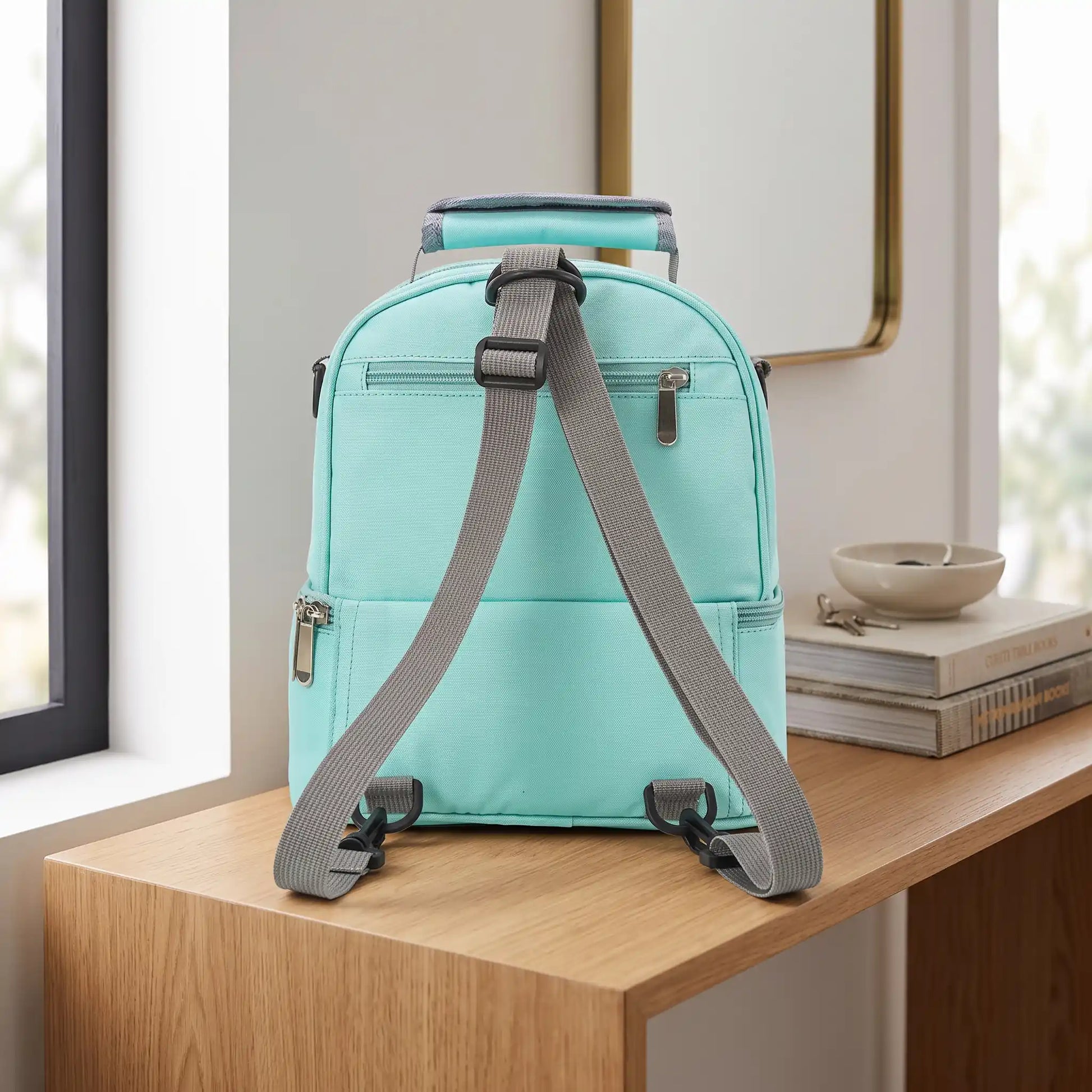 Sac bebe isotherme déposé sur un meuble en bois.